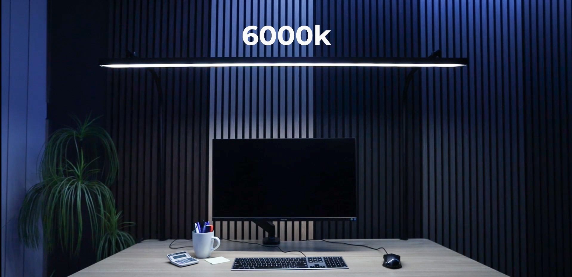 LightEFX Shift desk light set to 6000K cool daylight colour temperature, producing bright crisp white light over a desk with monitor and keyboard